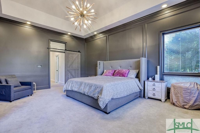 carpeted bedroom with a notable chandelier, a barn door, and crown molding