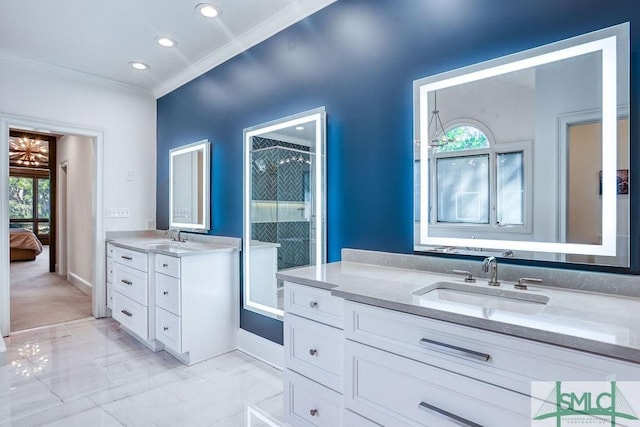 bathroom featuring a wealth of natural light, crown molding, and vanity