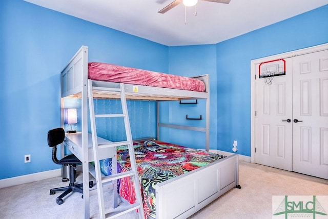 carpeted bedroom featuring ceiling fan and a closet