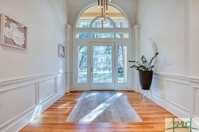 foyer with light hardwood / wood-style floors and an inviting chandelier