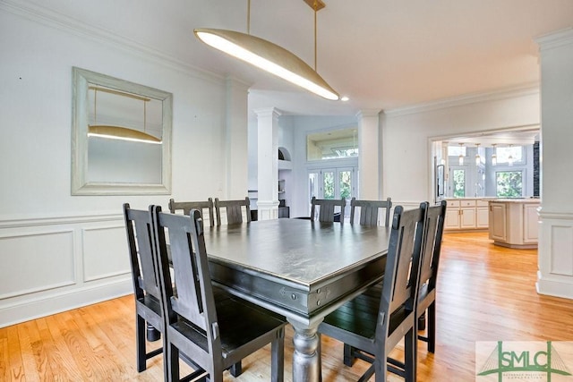 dining room featuring french doors, a wealth of natural light, and ornamental molding