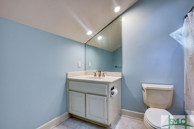 bathroom with tile patterned flooring, vanity, and toilet