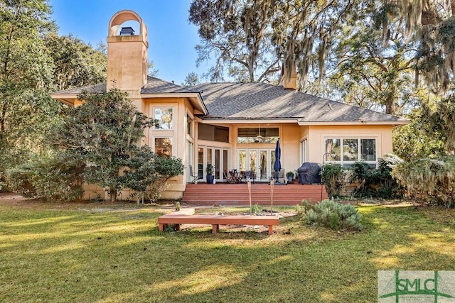 rear view of house with a yard