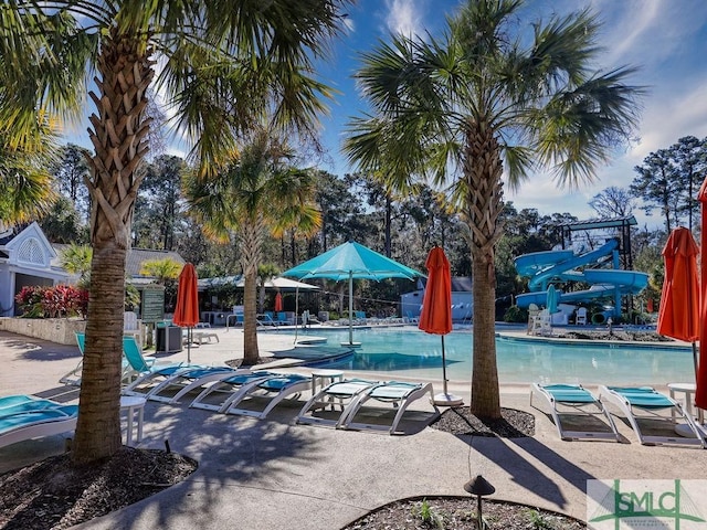 view of swimming pool featuring a patio and a water slide