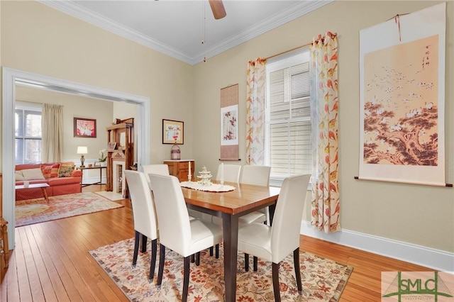 dining room featuring hardwood / wood-style floors, ceiling fan, and ornamental molding