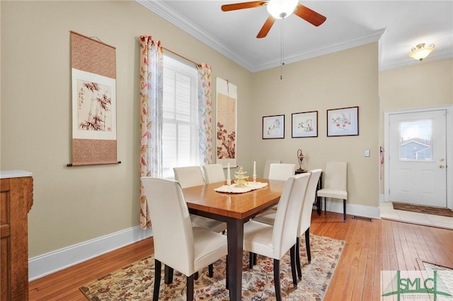 dining room featuring light wood-type flooring, ceiling fan, and ornamental molding