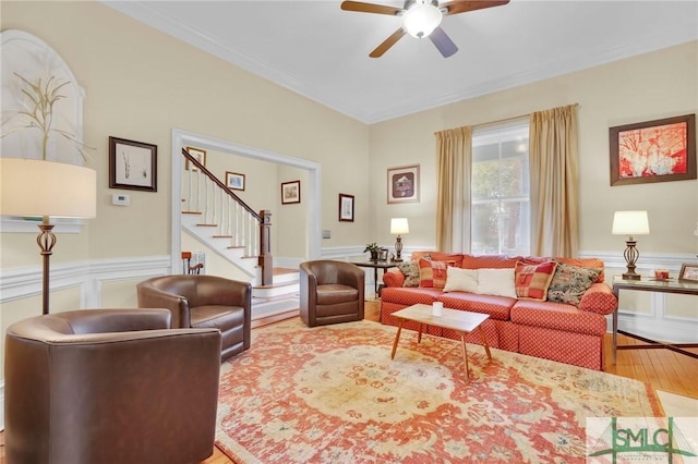 living room with hardwood / wood-style floors, ceiling fan, and ornamental molding