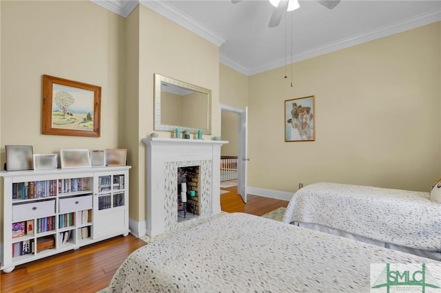 bedroom featuring ceiling fan, ornamental molding, and hardwood / wood-style flooring