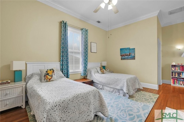 bedroom with wood-type flooring, ceiling fan, and ornamental molding