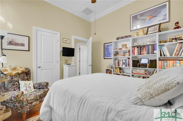 bedroom with hardwood / wood-style flooring and ornamental molding