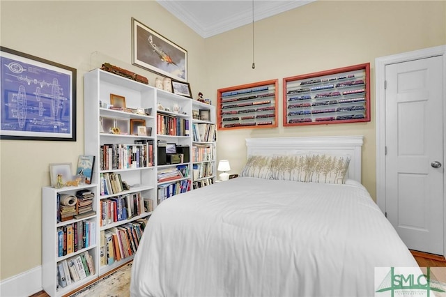 bedroom featuring hardwood / wood-style flooring and ornamental molding