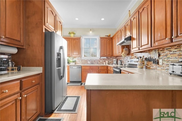 kitchen featuring tasteful backsplash, kitchen peninsula, crown molding, light hardwood / wood-style floors, and appliances with stainless steel finishes