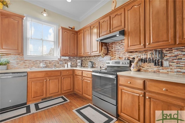 kitchen with backsplash, stainless steel appliances, ornamental molding, and sink