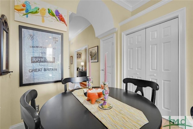 dining space featuring crown molding