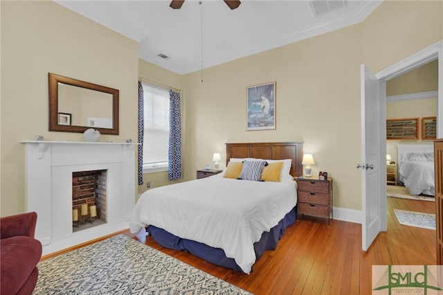 bedroom with ceiling fan, hardwood / wood-style floors, and ornamental molding