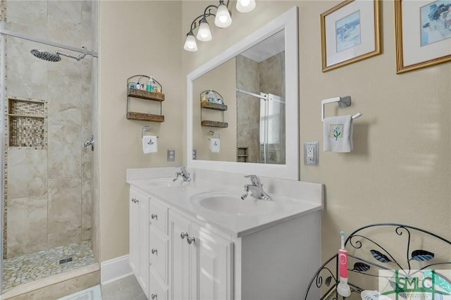 bathroom with tile patterned floors, vanity, and tiled shower