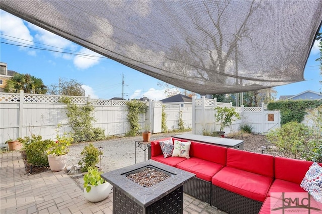 view of patio / terrace with an outdoor living space with a fire pit