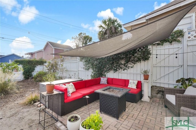 view of patio / terrace with an outdoor living space with a fire pit