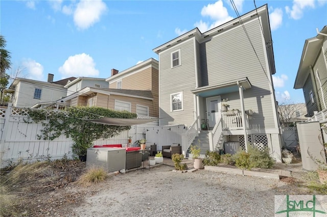 rear view of property with an outdoor hangout area