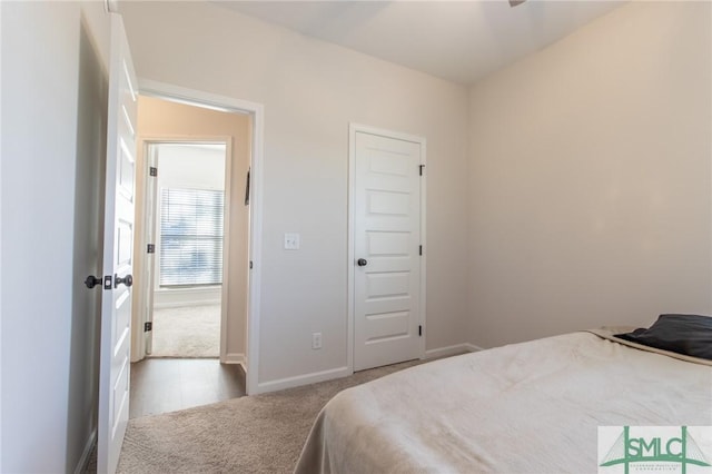 carpeted bedroom featuring baseboards