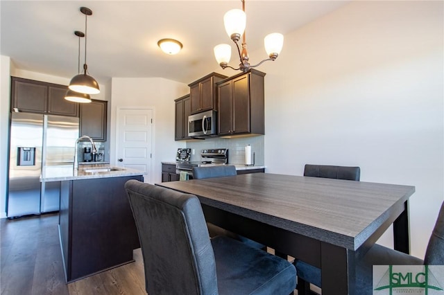 dining area featuring dark wood-style floors and a notable chandelier