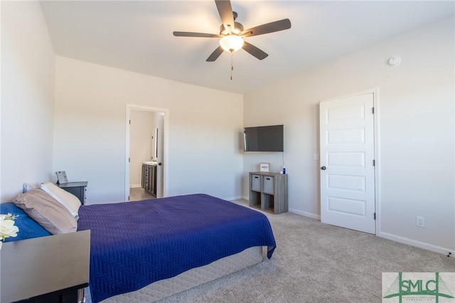 carpeted bedroom with ensuite bathroom, ceiling fan, and baseboards