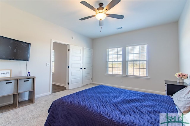 bedroom featuring baseboards, visible vents, ceiling fan, and carpet flooring