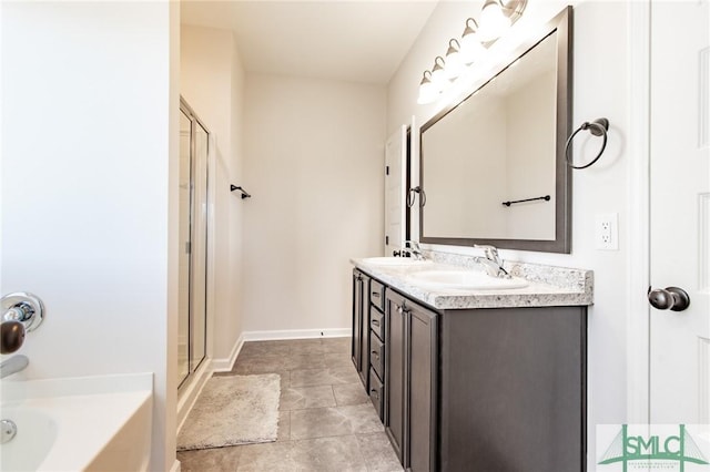 full bath with a bath, double vanity, a sink, and a shower with shower door