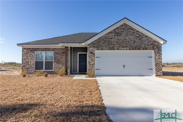 single story home featuring a garage, brick siding, and driveway