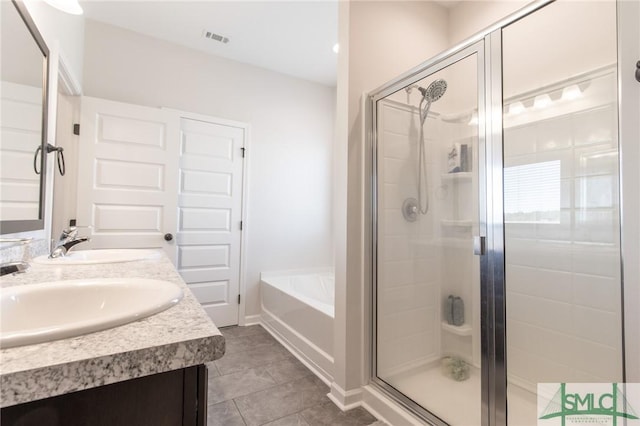 full bathroom featuring a stall shower, visible vents, a sink, and a bath