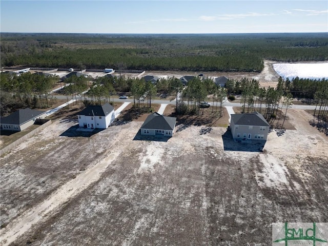 bird's eye view featuring a wooded view