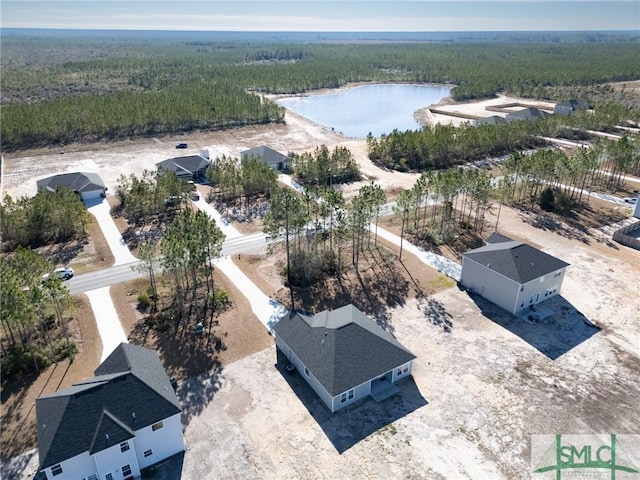 aerial view with a water view and a forest view