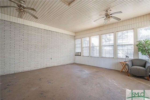 unfurnished sunroom featuring ceiling fan