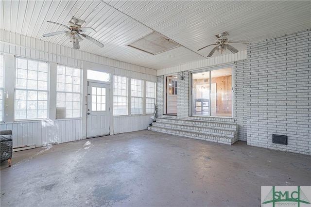 unfurnished sunroom featuring ceiling fan