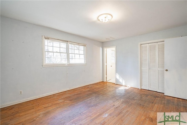 unfurnished bedroom with hardwood / wood-style floors