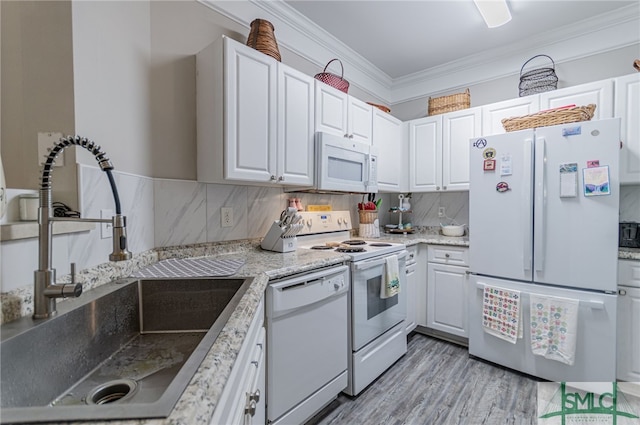 kitchen featuring white cabinets, backsplash, white appliances, and sink