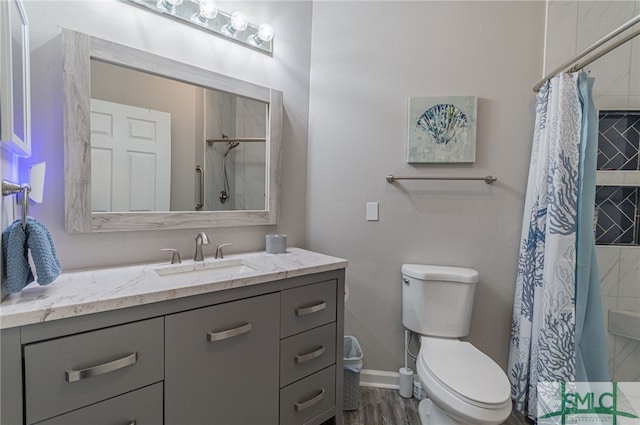 bathroom featuring hardwood / wood-style floors, vanity, curtained shower, and toilet