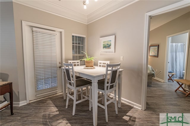 dining room featuring dark wood-type flooring and ornamental molding