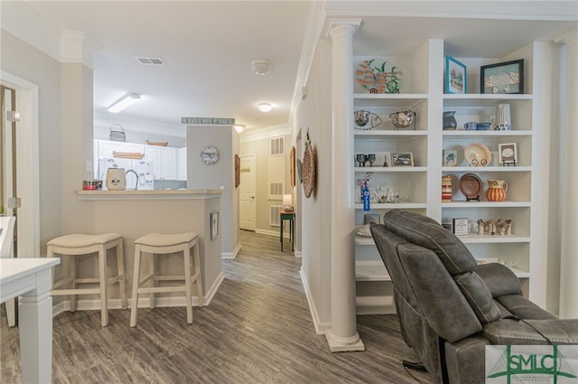 interior space with wood-type flooring and ornamental molding