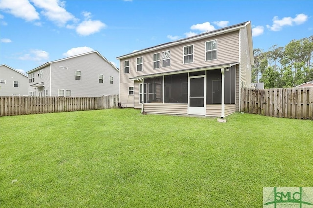 rear view of property featuring a yard