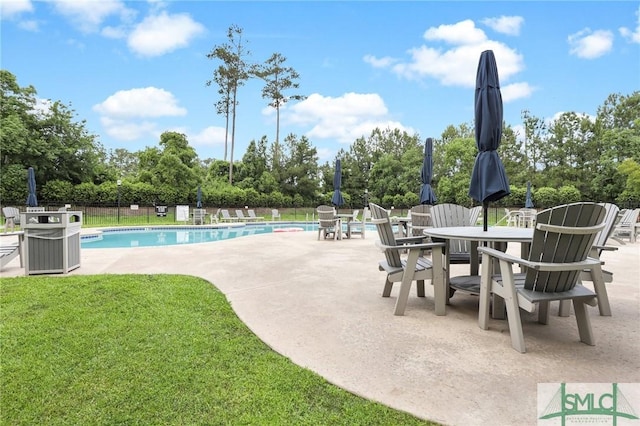 view of pool with a yard and a patio