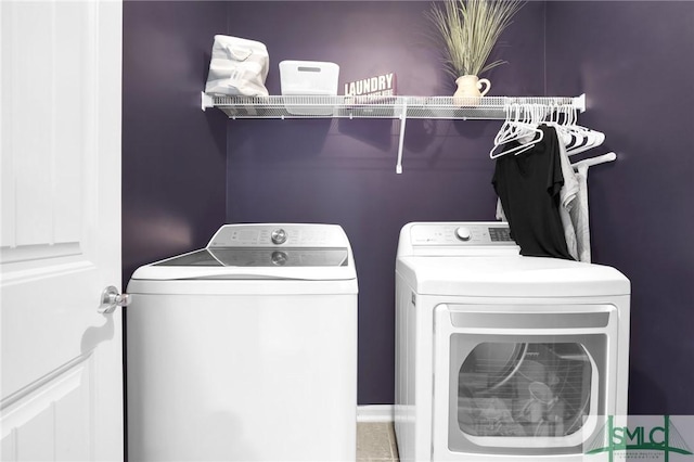 clothes washing area featuring separate washer and dryer