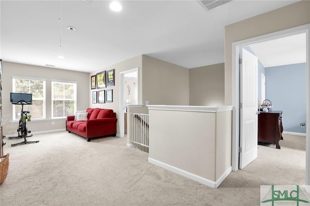 hallway featuring light colored carpet