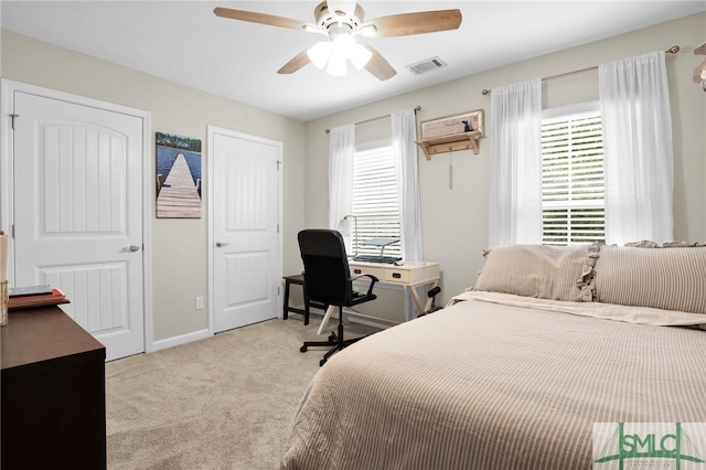 bedroom with light colored carpet and ceiling fan