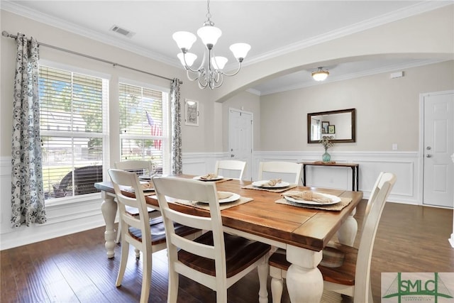 dining space featuring ornamental molding, dark hardwood / wood-style floors, and a notable chandelier