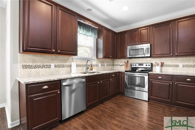 kitchen featuring appliances with stainless steel finishes, dark hardwood / wood-style floors, crown molding, and sink