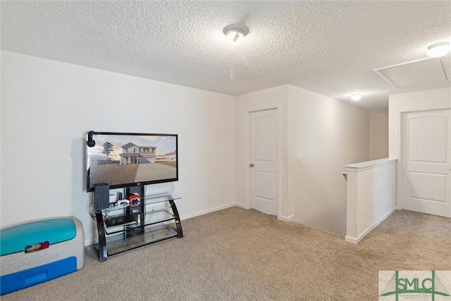 interior space with light carpet and a textured ceiling