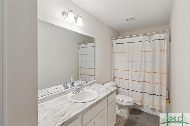 full bathroom with vanity, shower / tub combo, a textured ceiling, and toilet