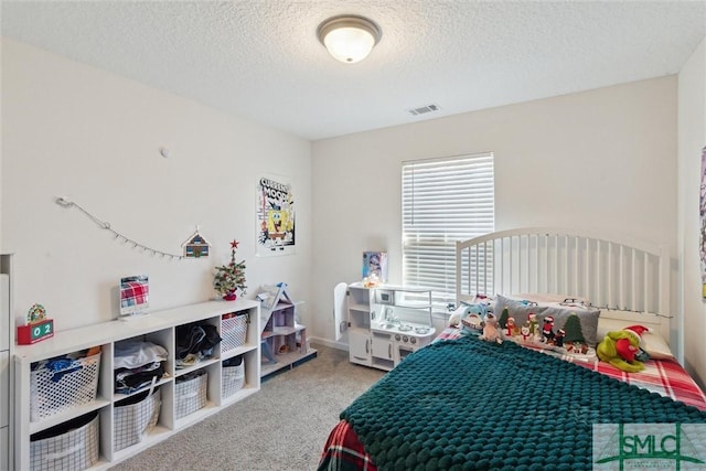 bedroom featuring carpet floors and a textured ceiling