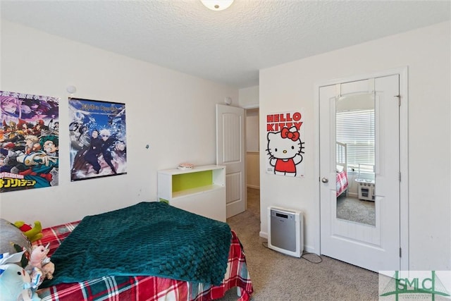 bedroom featuring carpet and a textured ceiling